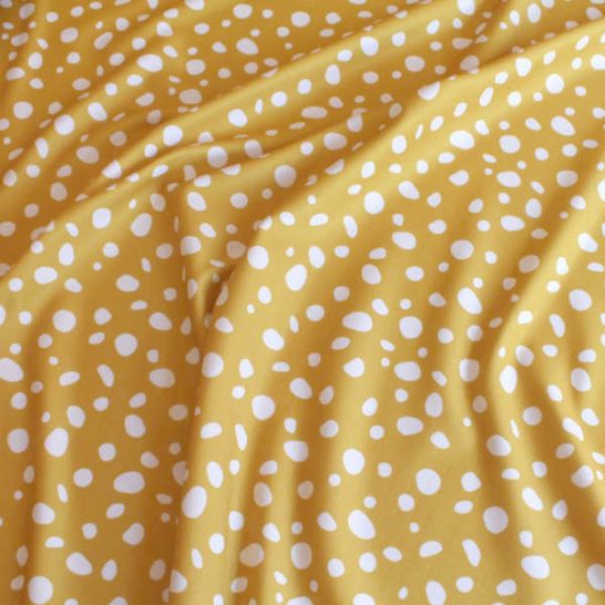 Tela de lycra elástica estampado amarillo mostaza manchas lunares para confeccionar ropa de baño